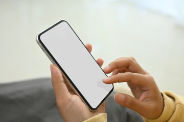 Close up of woman relaxing and holding smartphone with blank display