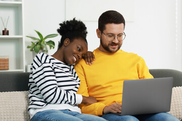Fototapeta premium International relationships. Lovely couple spending time together at home