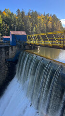 A dam on a river with water falling down. The Bobr River, Poland © PRO Balance
