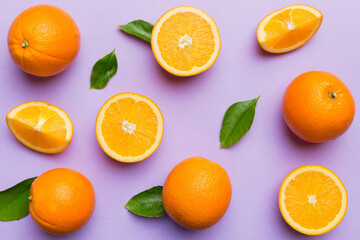 Fruit pattern of fresh orange slices on colored background. Top view. Copy Space. creative summer concept. Half of citrus in minimal flat lay