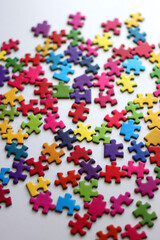 Colorful jigsaw puzzle pieces on white background. Selective focus.