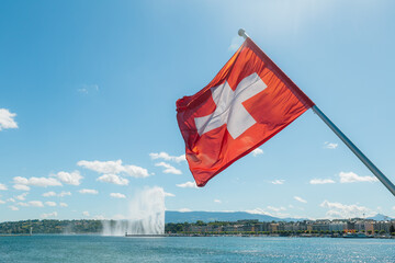 Swiss Flag Waving by Lake Geneva on a Sunny Day