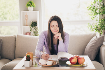 Photo of nice young teen girl study do homework wear violet clothes enjoy modern cozy bright interior flat indoors