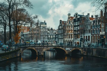 Fototapeta premium Picturesque view of amsterdam's canals lined with traditional dutch houses and a bridge bustling with activity