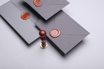 Floating Envelopes with wax seals and vintage stamp on gray background. Gift certificate, wedding...