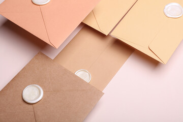 Floating Envelopes with wax seals on beige background. Gift certificate, wedding invitation....
