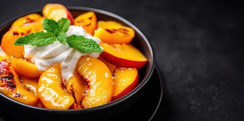 Delicious grilled peaches drizzled with honey glaze, topped with whipped cream and fresh mint leaves.