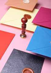 Floating colored Envelopes with wax seals, vintage stamp on pink background. Gift certificate,...