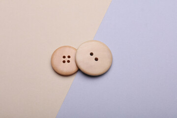 Wooden buttons on a pastel background close up