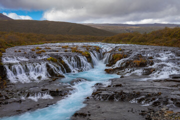 Wide Waterfall in Iceland with Blue Water