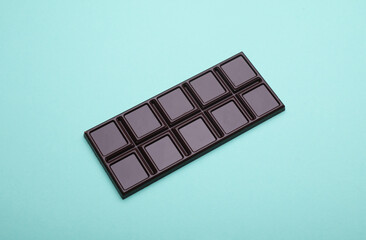 Dark chocolate bar on a blue background