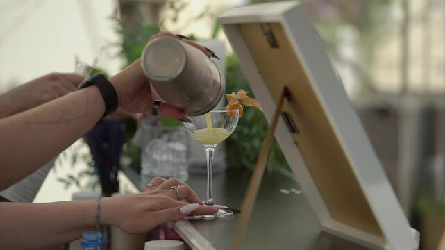 The bartender skillfully shakes a cocktail, showcasing mixology artistry and creating a delightful experience