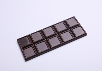 Dark chocolate bar on a white background