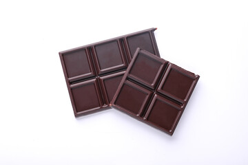 Blocks of broken chocolate bar on white background