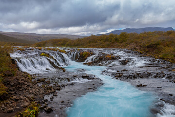 Wide Waterfall in Iceland with Blue Water
