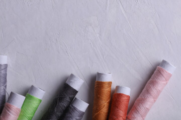 Set of colored threads on a concrete background
