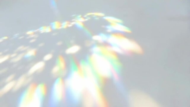 Rainbow Light and Shadow Overlay Effect on White Background. Abstract Colorful Refraction, Trendy Visuals. 4K Video