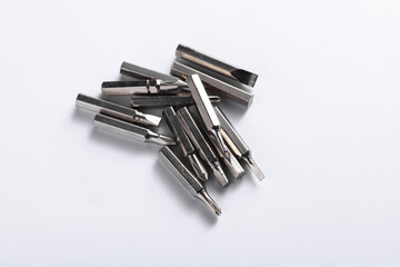 Set of metal screwdriver bits on white background