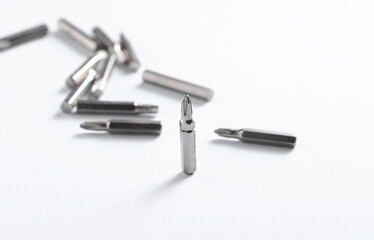 Set of metal screwdriver bits on white background