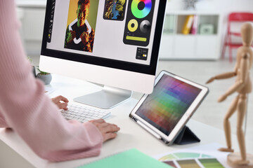 Designer working at table in office, closeup