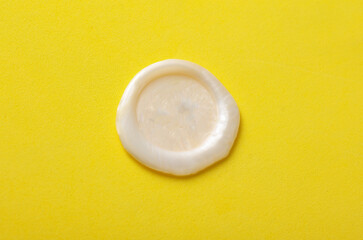 Mockup of white wax seal on yellow background
