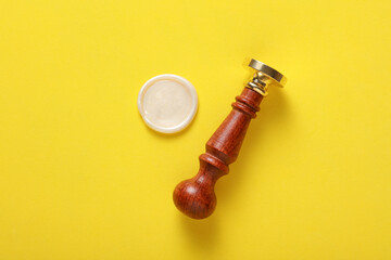 Vintage personal stamp and wax seal on yellow background