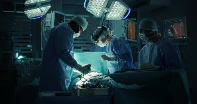 Lead Surgeon Navigating Complex Steps in Real-Time with the Help of an Augmented Reality Glasses. Female Medical Professional is Aided by Nurses and Surgical Assistants in a Coordinated Teamwork