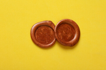 Brown wax seals on yellow background
