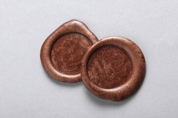 Brown wax seals on a gray background