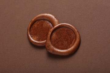 Wax seals on a brown background