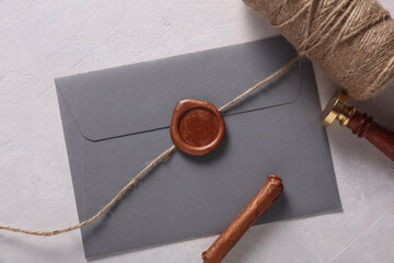 Envelope with wax seals and vintage stamp, thread on gray background. DIY, Gift certificate,...