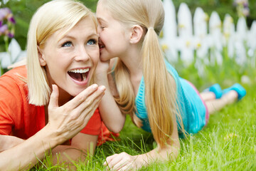 Cute, whisper and child with mom, outdoor and wow for gossip, rumor and telling of secret to woman....