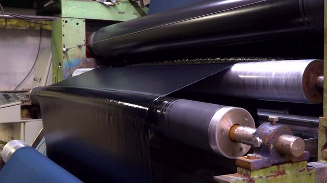 Close up of a machine dyeing fabric in a textile factory