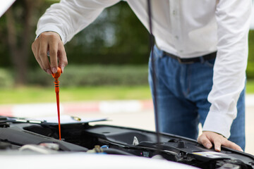 salesman is checking condition of car before delivering it to customer to ensure the quality and service after agreeing to sales contract. concept of checking the condition of the car for confidence