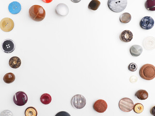A collection of vintage buttons as a border on a white studio background