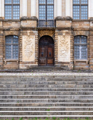 Entrance of a historic parliament building in Rennes with ornate stonework and large windows.
