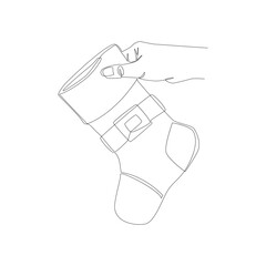 Line art hand holding a New Year's sock. Vector illustration on a white background. New Year's mood, holiday. Postcard, banner, icon.