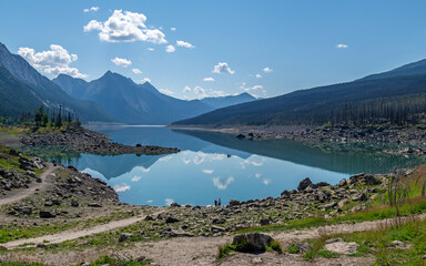 Medicine lake reflection with people silhouette, Jasper national park, Canada.