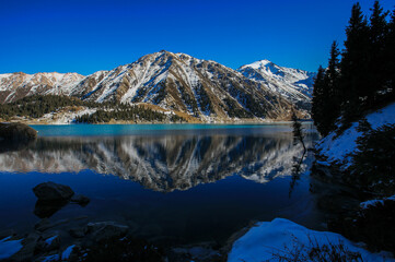 Obraz premium Big Almaty Lake is a high-mountain reservoir in the Trans-Ili Alatau at an altitude of 2510 meters above sea level, 15 kilometers south of the city of Almaty.
