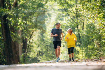 Obraz premium Casual jogging, sport conception. Senior couple together outdoors at nature