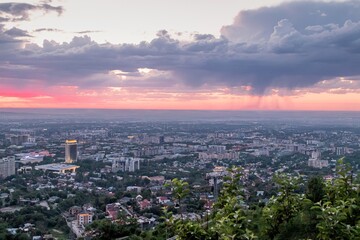 Panoramic view of the city of Almaty from the observation deck, sunset, summer time. Sights of Kazakhstan.