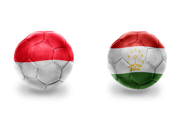 football balls with national flags of tajikistan and indonesia,soccer teams. on the white background.