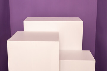 Pedestal for product and packaging mockups with white shapes over violet background. High quality photo