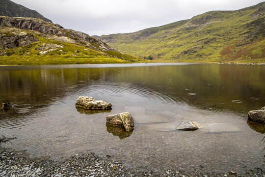Near Blaenau Ffestiniog, Gwynedd,, UK - June 21, 2017: Llyn Cwmorthin with the ruin of Cwmorthin Terrace, the Compressor House and the quarry in the background