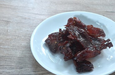 salty and sweet dry fried slice beef meat fermenting in sesame oil and pepper on plate