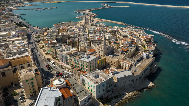 Aerial view of the historic center of Molfetta, in the province of Bari, Puglia, Italy. The Old Town has many churches and is located on the Mediterranean Sea. In background the port of the city.