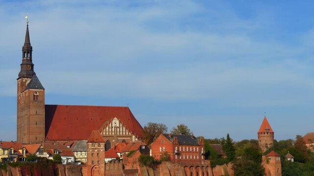 beautiful view of the city wall of the medieval town of Tangerm&uuml;nde in Saxony-Anhalt, Germany, St. Stephan church and historical buildings on a sunny day with blue sky background in late summer