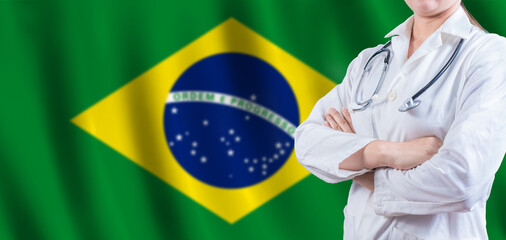 Doctor with crossed arms on Brazilian flag. Brazilian Health and Care concept. Female doctor on Brazil flag