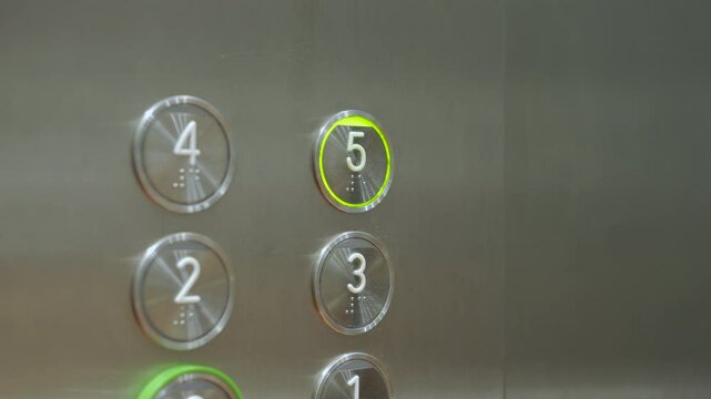 Video profile of a man pressing a five button in an elevator