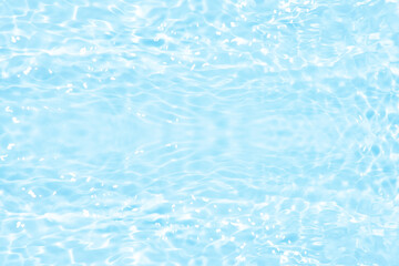 Blue water with ripples on the surface. Defocus blurred transparent blue colored clear calm water surface texture with splashes and bubbles. Water waves with shining pattern texture background.